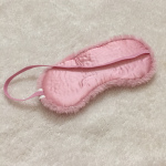  Photo shows a pink fuzzy I'm ask on a white background 