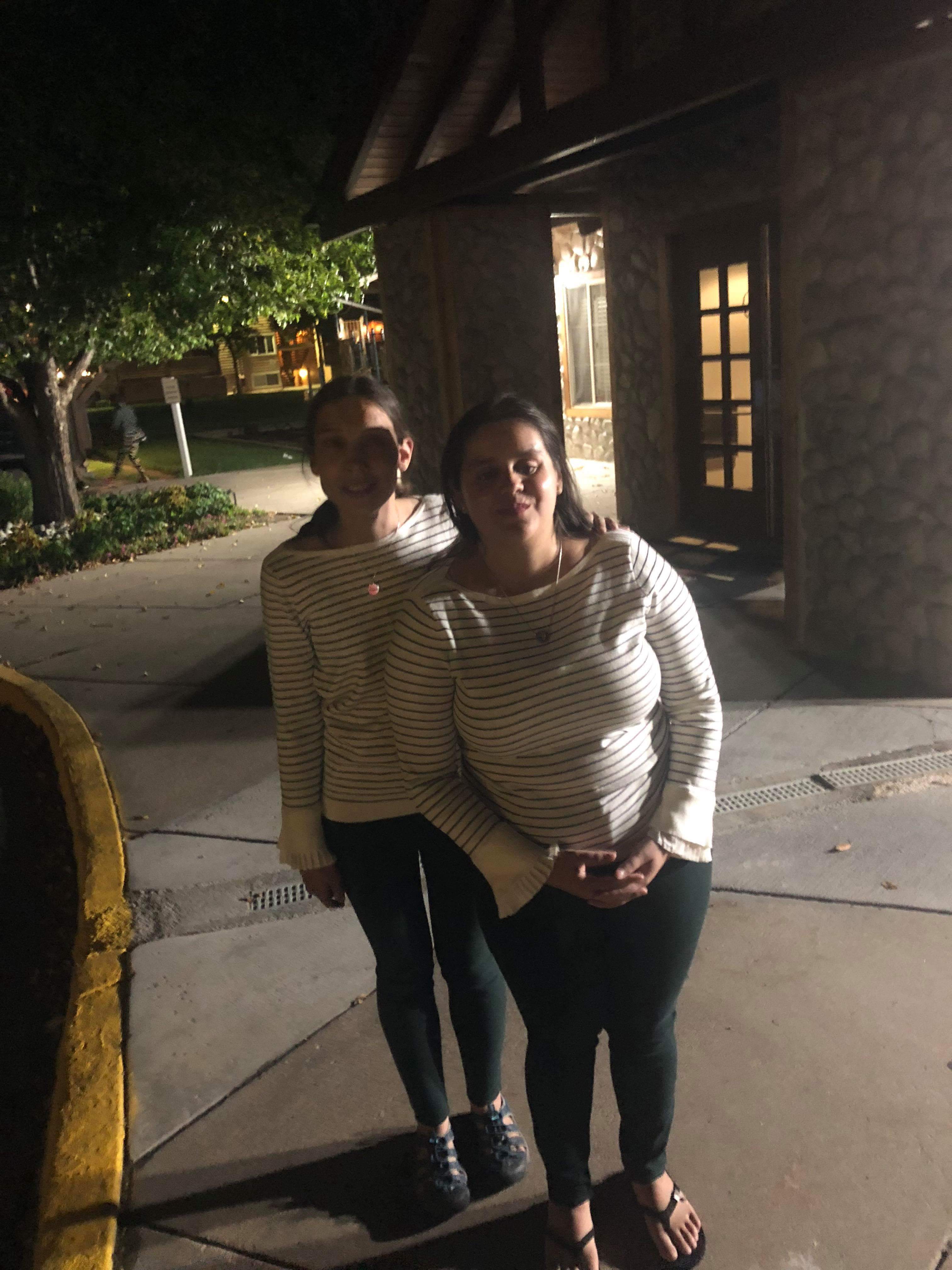 We are wearing matching dark green leggings and cream-coloured sweaters